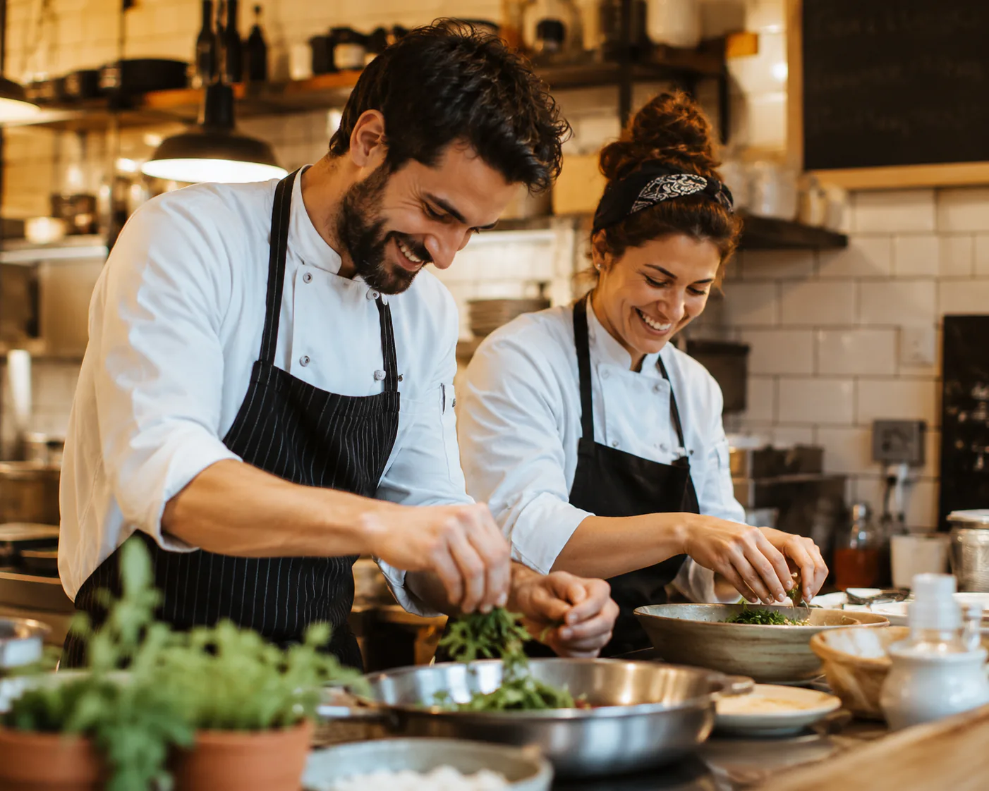 Maya and Tom preparing seasonal dishes in the Willow and Hearth kitchen